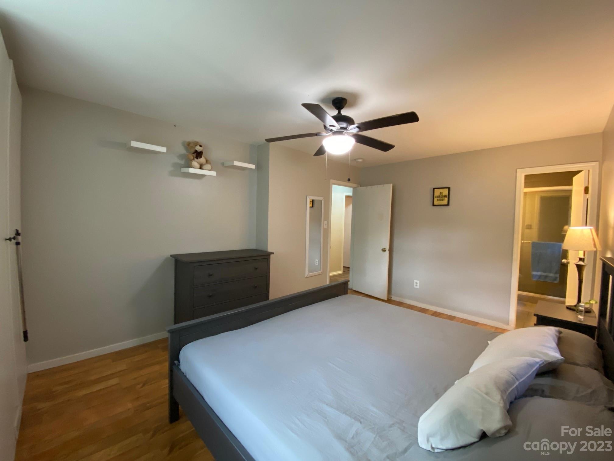 5901 Potter Road Matthews, NC 28104 - Photo 24 of 38 a bedroom with a large bed and a chandelier