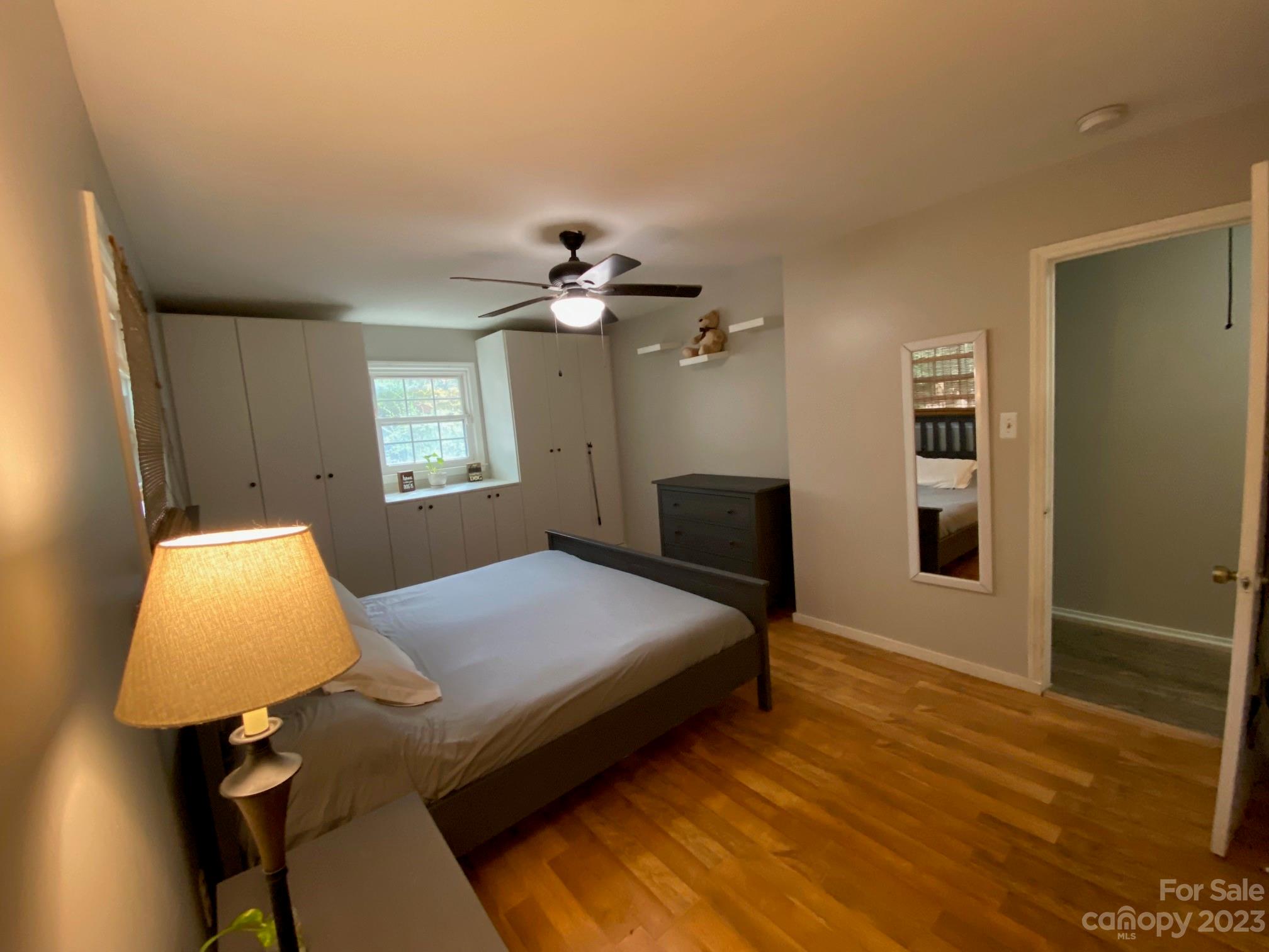 5901 Potter Road Matthews, NC 28104 - Photo 25 of 38 a spacious bedroom with a bed and a lamp