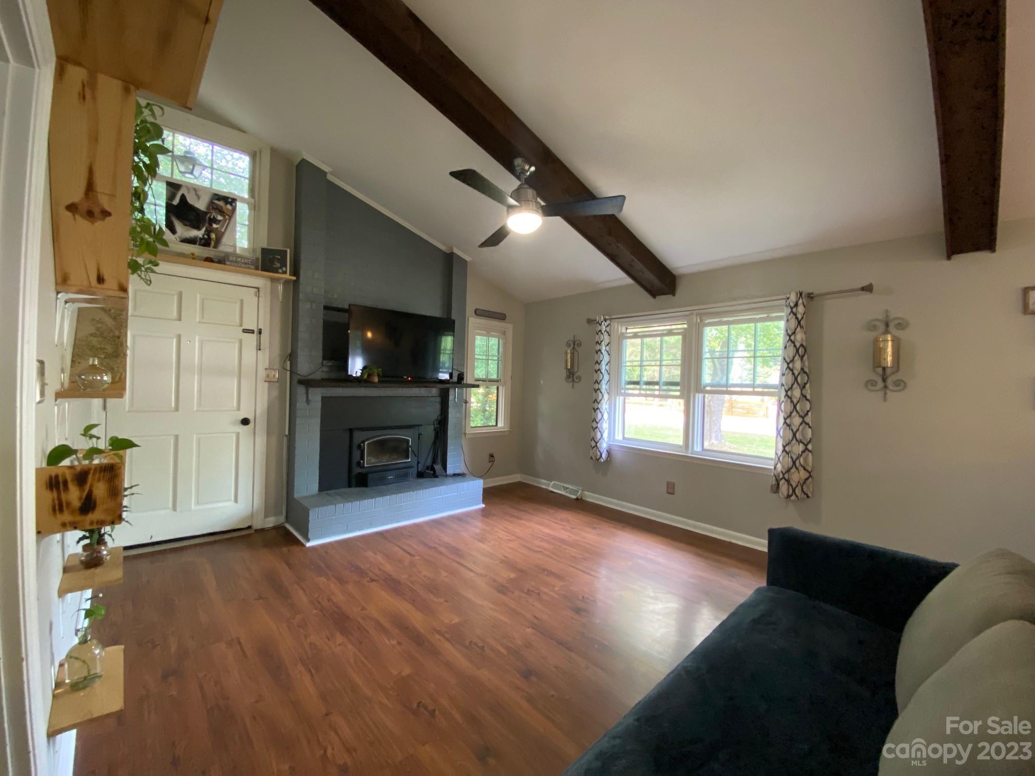 5901 Potter Road Matthews, NC 28104 - Photo 9 of 38 a view of an empty room with a fireplace and a window