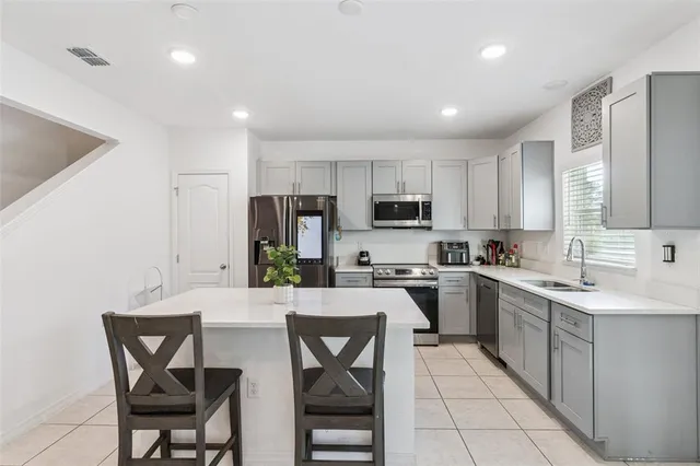 a kitchen with a sink stove and refrigerator