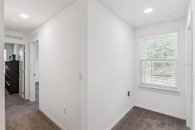 a bed sitting in a bedroom next to a window