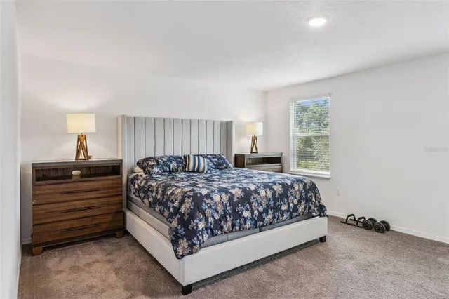 a bedroom with a bed and a chair