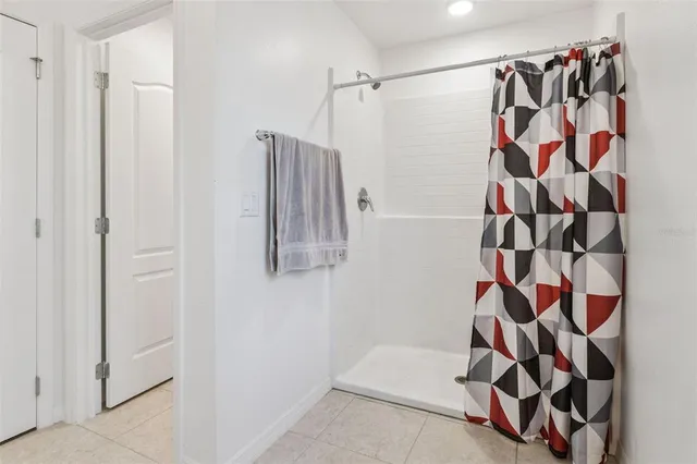 a kitchen with granite countertop a refrigerator and a stove top oven