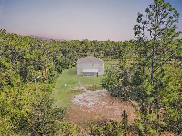 an aerial view of a houses with a yard