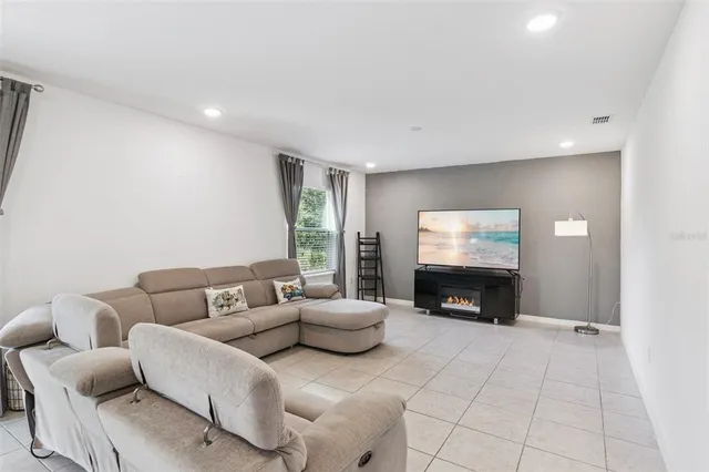 a kitchen with a refrigerator a stove a sink and chairs