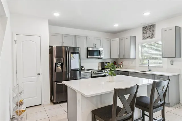 a view of kitchen island a sink and living room