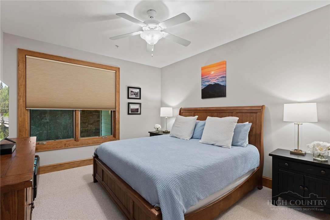 142 Evening View Lane, Unit CA3 Boone, NC 28607 - Photo 21 of 41 a bedroom with a bed and a chandelier