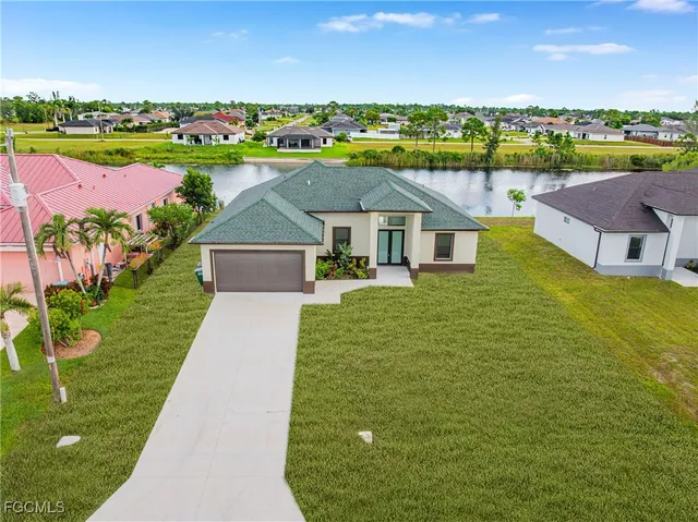 a view of a house with a yard and lake view