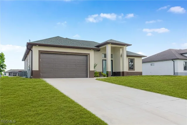 a front view of a house with a yard and garage