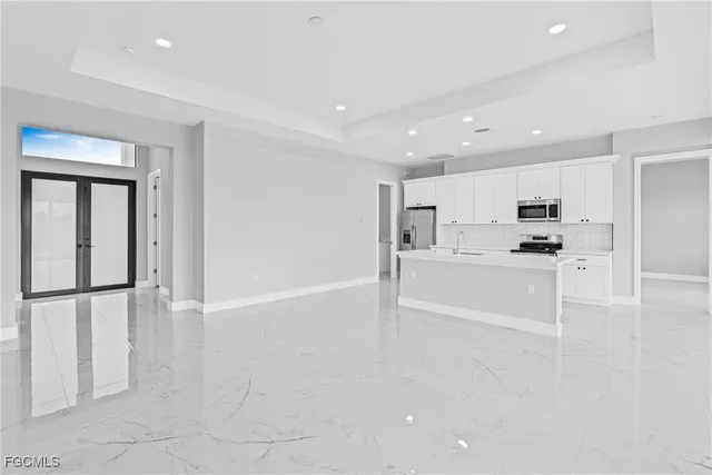a view of kitchen with refrigerator and window
