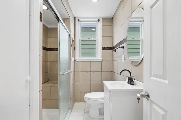 a bathroom with a toilet sink and shower