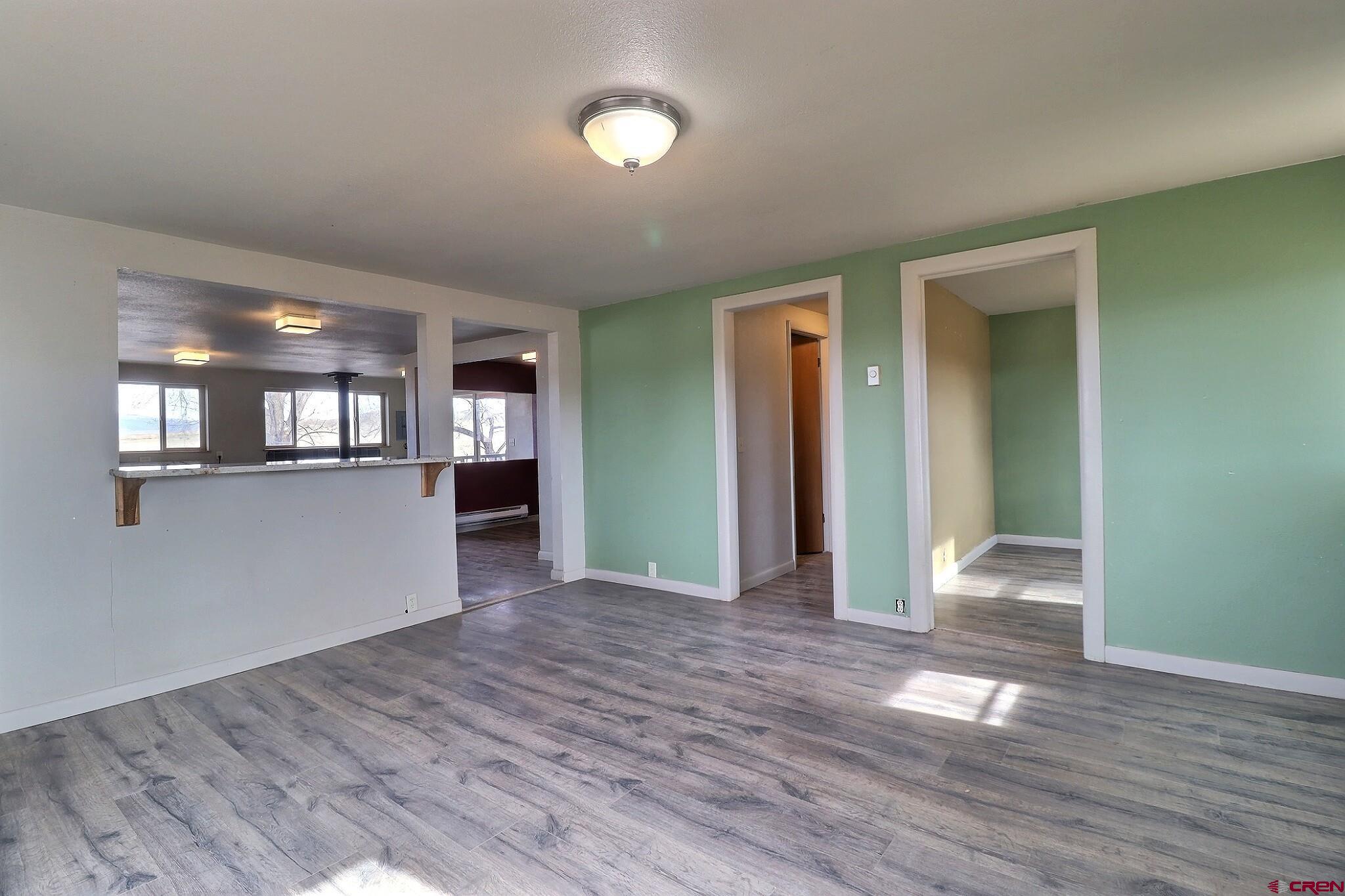 34607 F50 Road Hotchkiss, CO 81419 - Photo 18 of 38 a view of a livingroom with wooden floor and kitchen space