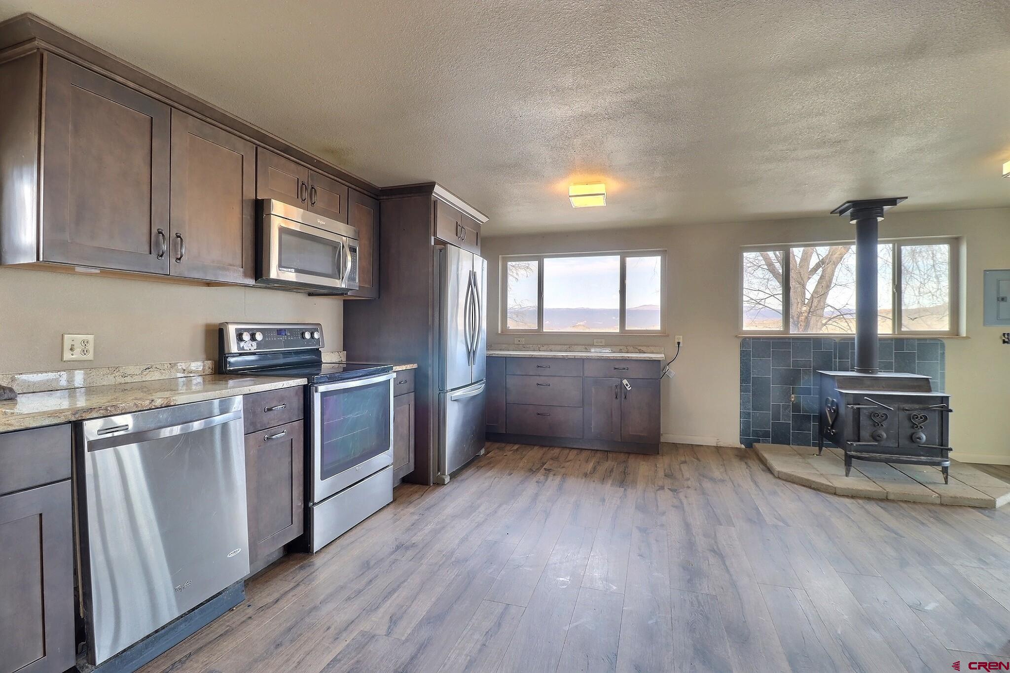 34607 F50 Road Hotchkiss, CO 81419 - Photo 19 of 38 a kitchen with a refrigerator and wooden cabinets