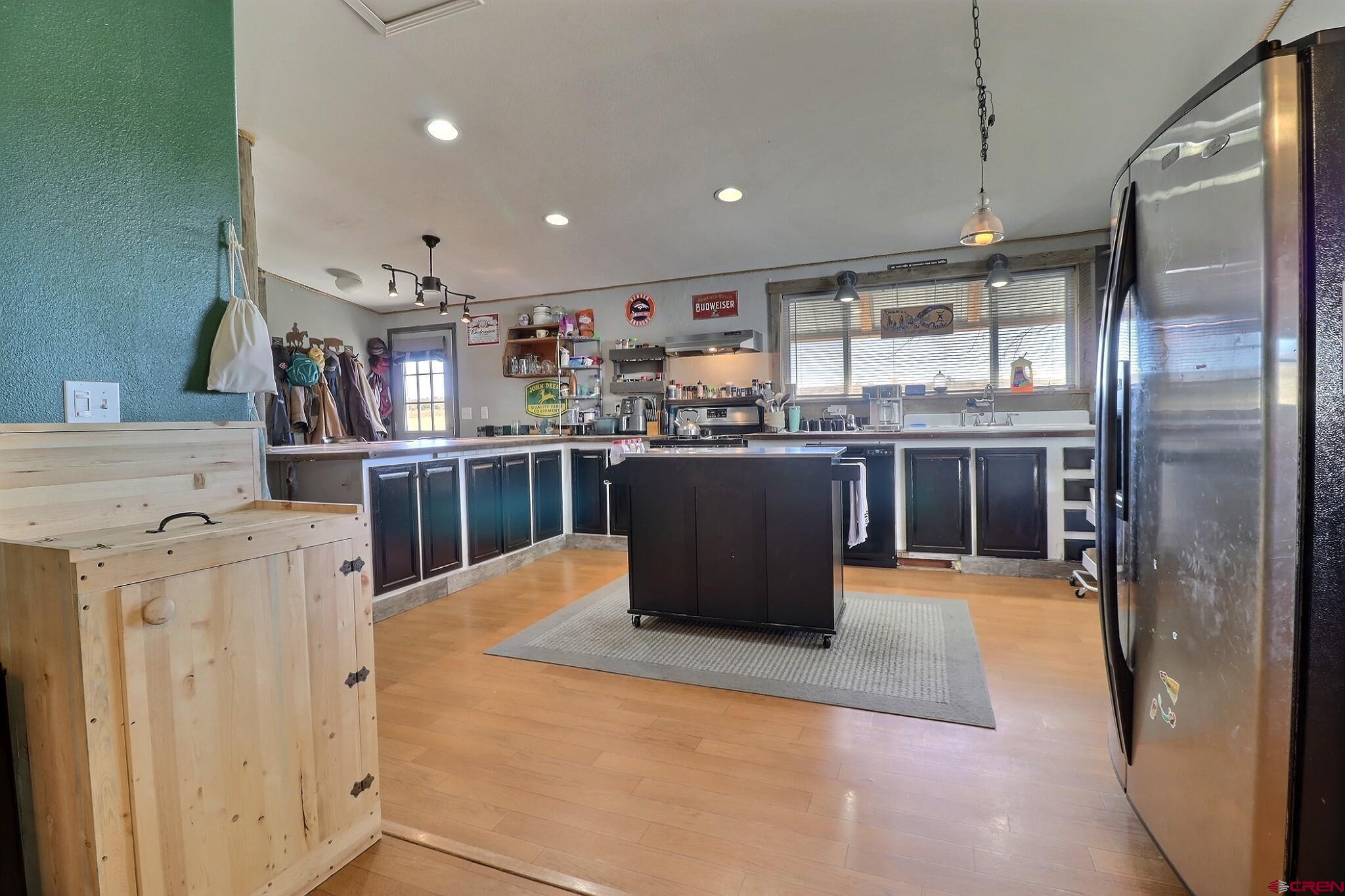 34607 F50 Road Hotchkiss, CO 81419 - Photo 24 of 38 a kitchen with stainless steel appliances kitchen island granite countertop a table chairs and a refrigerator