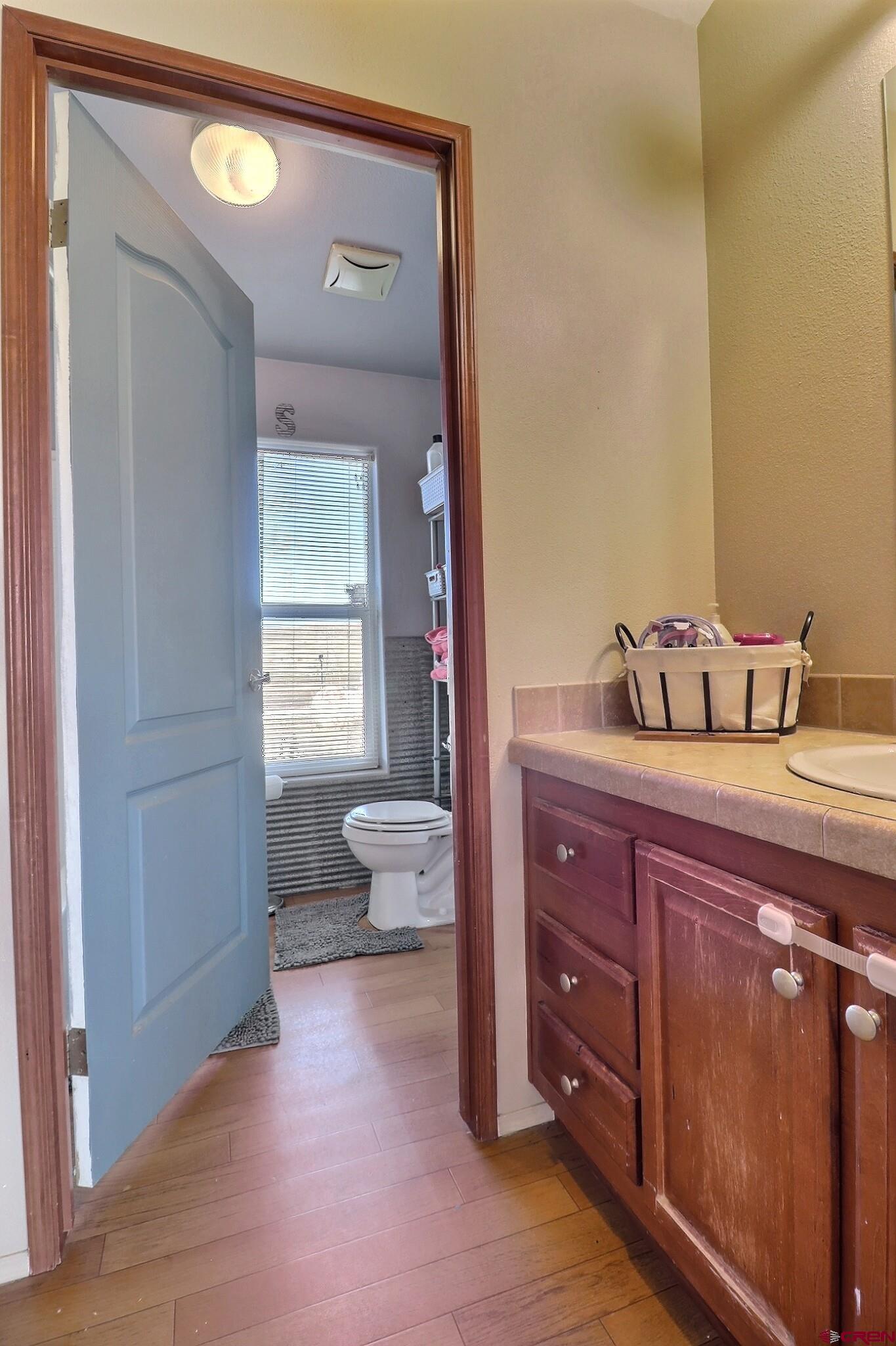 34607 F50 Road Hotchkiss, CO 81419 - Photo 29 of 35 a bathroom with a toilet a sink and mirror