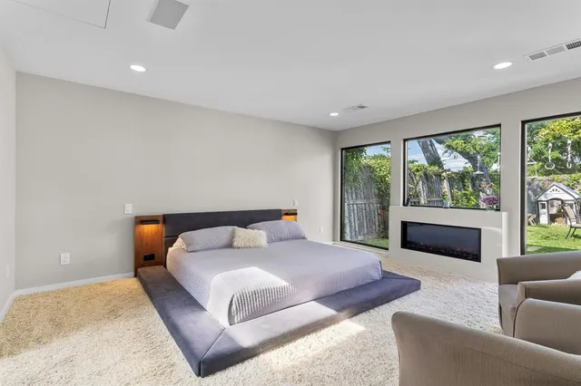 a bedroom with a large bed and a couch