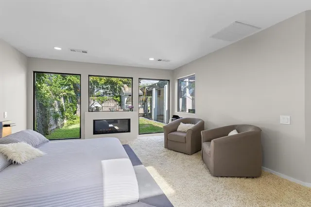 a living room with furniture and a floor to ceiling window