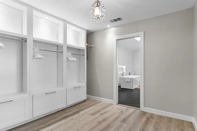 a view of an empty room with a kitchen