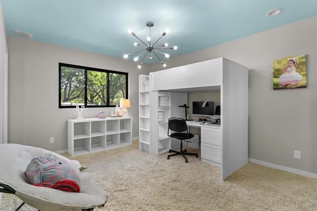 a view of a livingroom with workspace and a window