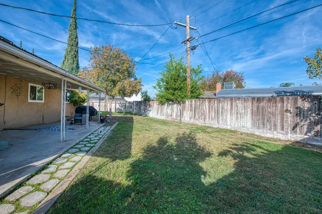 a view of a backyard with wooden fence
