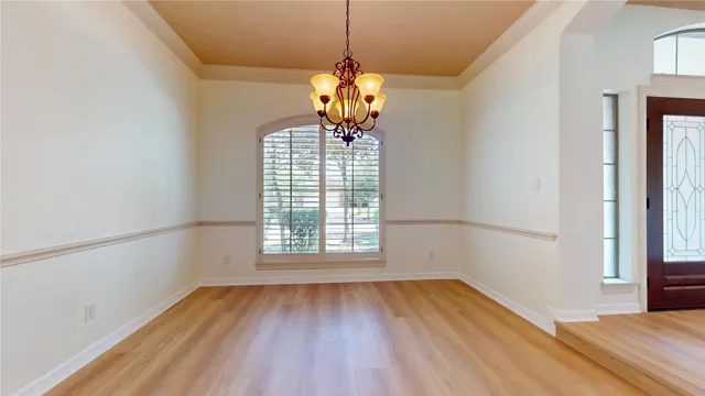 a view of a room with wooden floor and a window