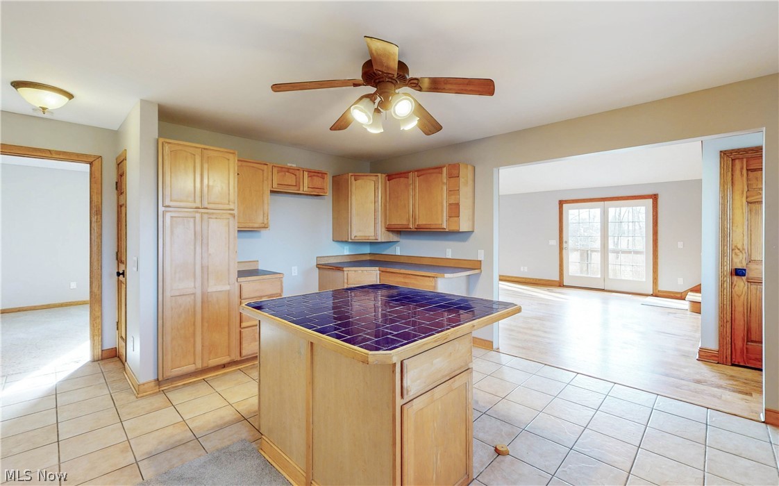 2081 Stroup Road Atwater, OH 44201 - Photo 21 of 48 Kitchen with a kitchen island, light tile floors, light brown cabinetry, and ceiling fan