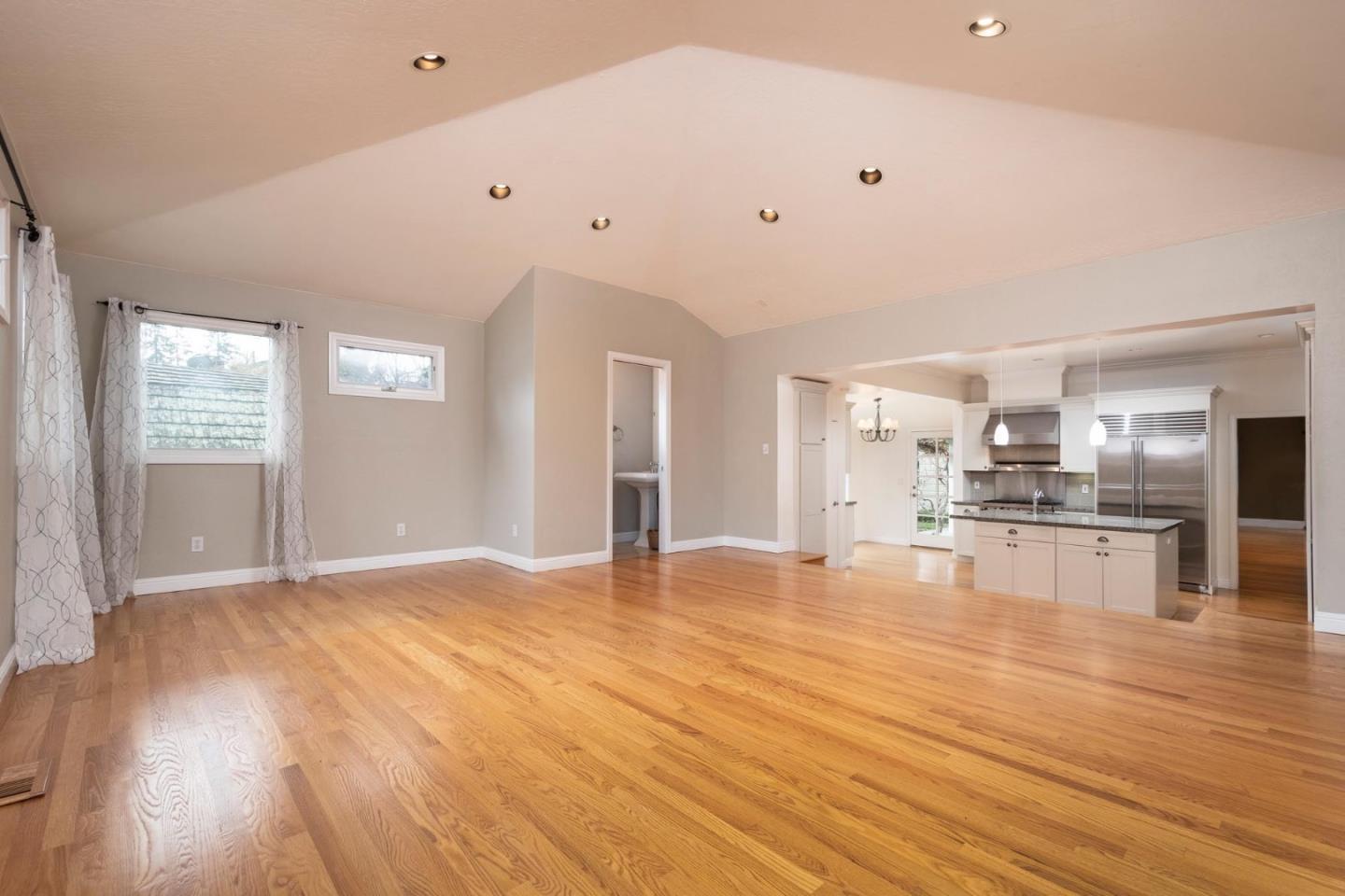 1508 Arc Way Burlingame, CA 94010 - Photo 11 of 18 a view of a kitchen with kitchen island a sink wooden floor and living room view