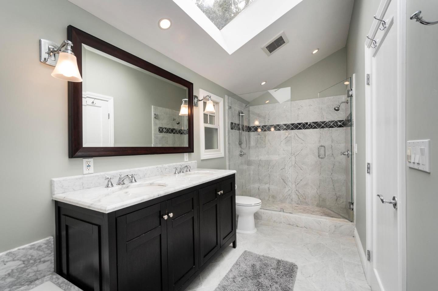 1508 Arc Way Burlingame, CA 94010 - Photo 14 of 18 a bathroom with a double vanity sink mirror double shower and a bathtub