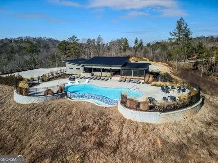 a view of a house with pool table and chairs