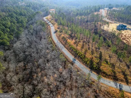 a view of a yard with wooden fence