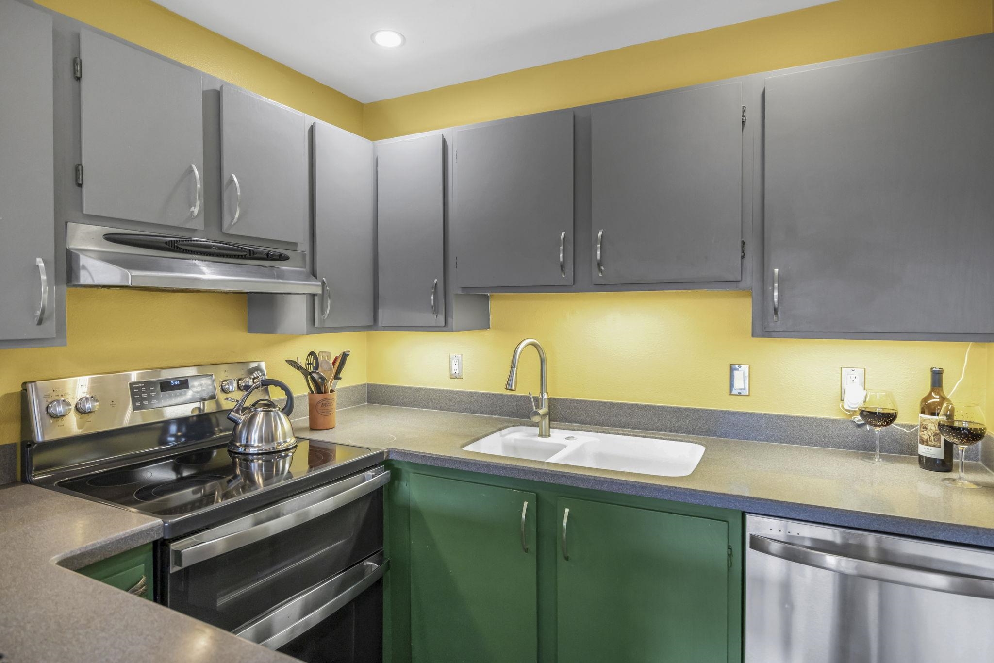 3740 Lower Honoapiilani Road, Unit C205 Lahaina, HI 96761 - Photo 18 of 28 a kitchen with stainless steel appliances granite countertop a sink a stove and a microwave