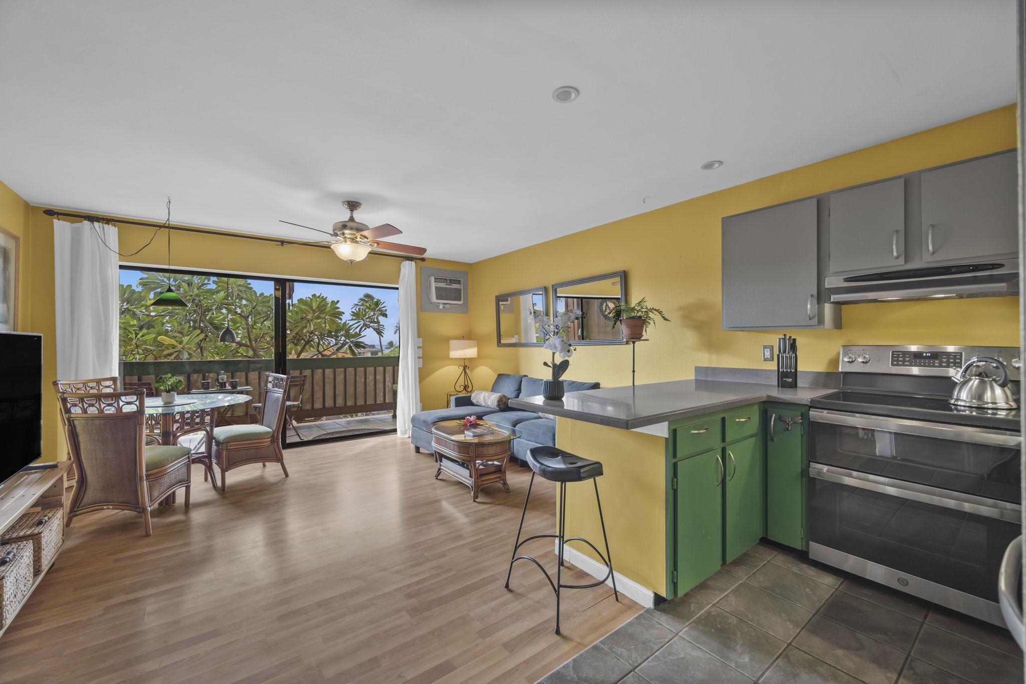 3740 Lower Honoapiilani Road, Unit C205 Lahaina, HI 96761 - Photo 4 of 28 a living room with furniture and a large window