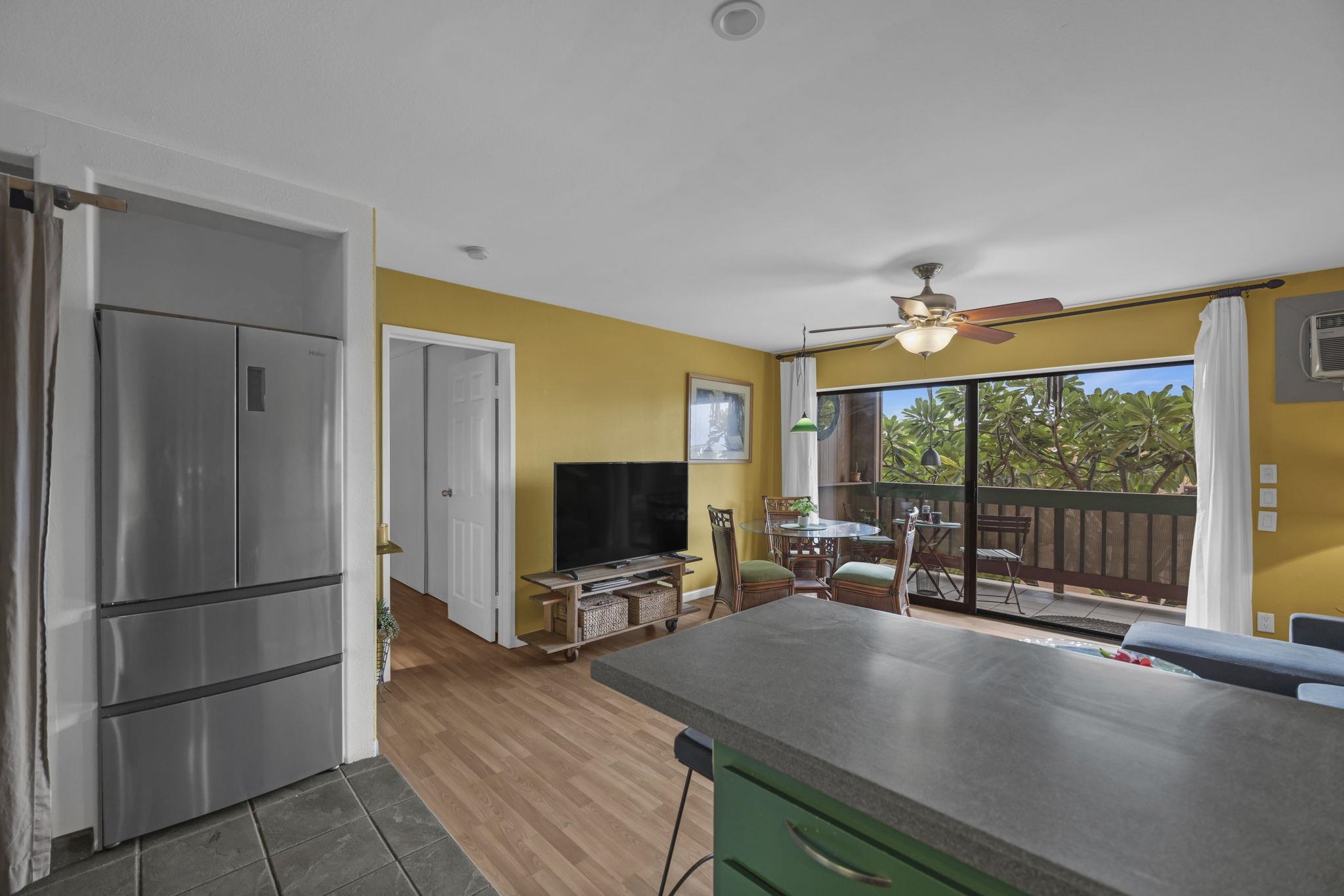 3740 Lower Honoapiilani Road, Unit C205 Lahaina, HI 96761 - Photo 5 of 28 a room with furniture and a flat screen tv