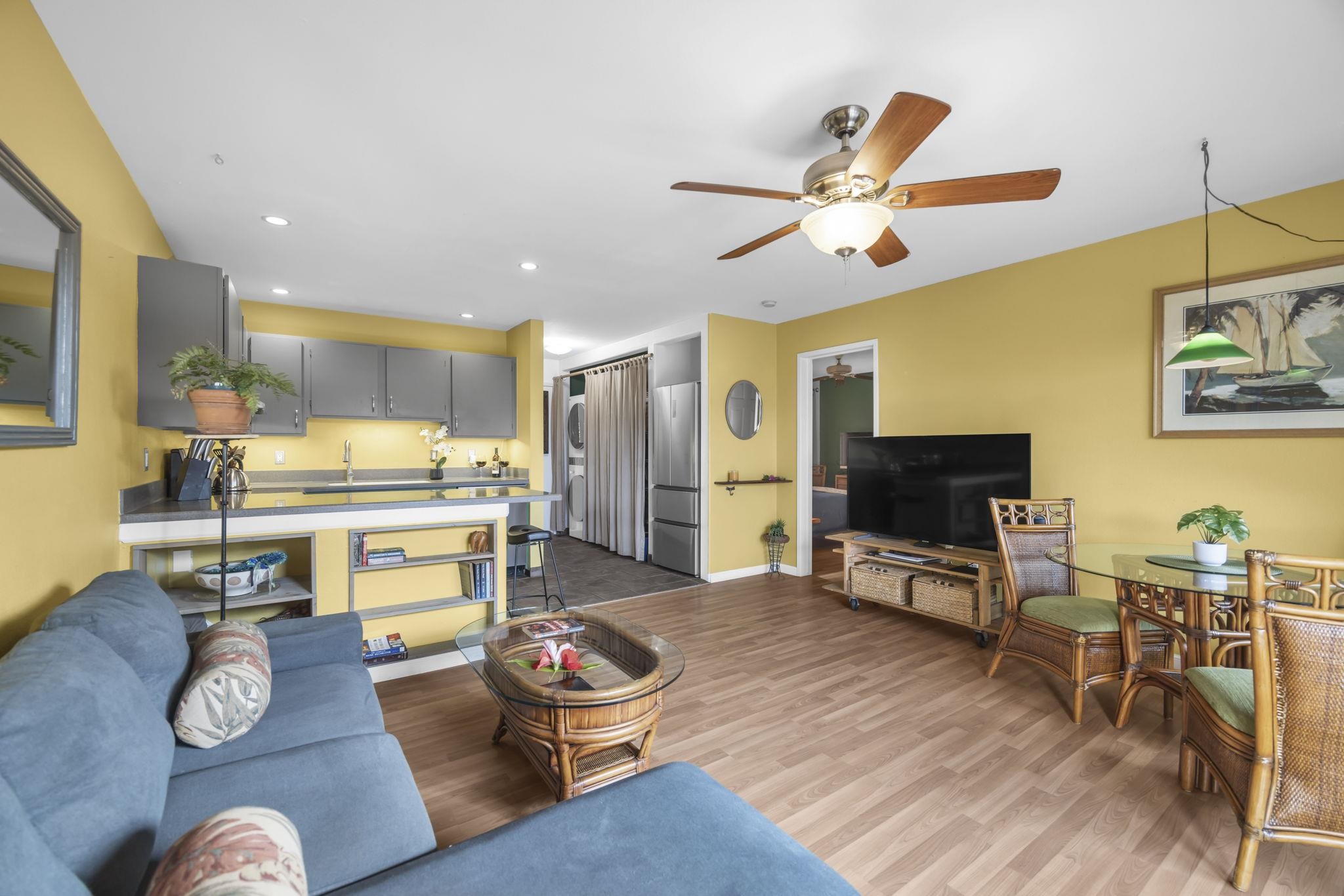 3740 Lower Honoapiilani Road, Unit C205 Lahaina, HI 96761 - Photo 7 of 28 a living room with furniture kitchen view and a wooden floor