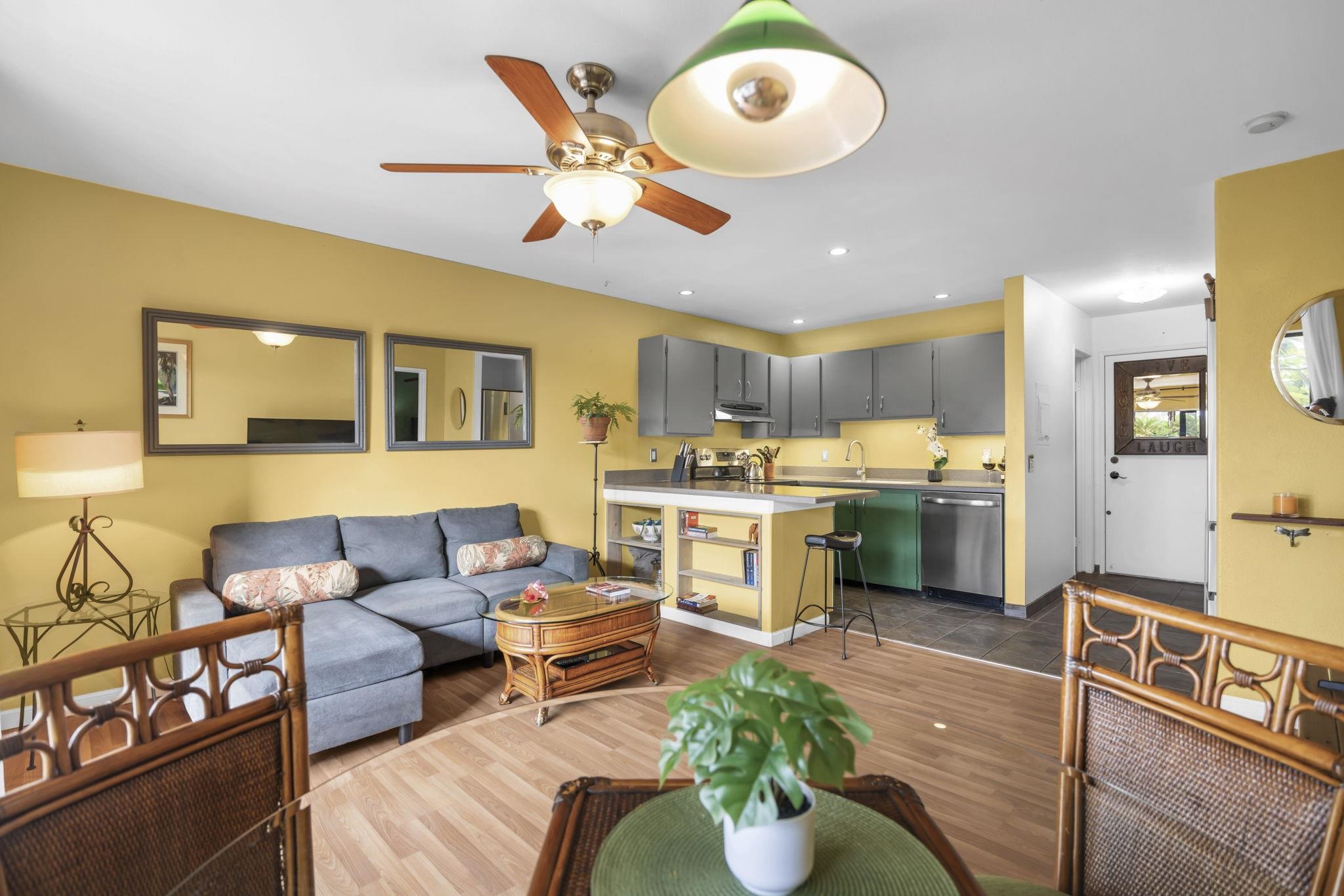 3740 Lower Honoapiilani Road, Unit C205 Lahaina, HI 96761 - Photo 8 of 28 a living room with furniture kitchen view and a chandelier