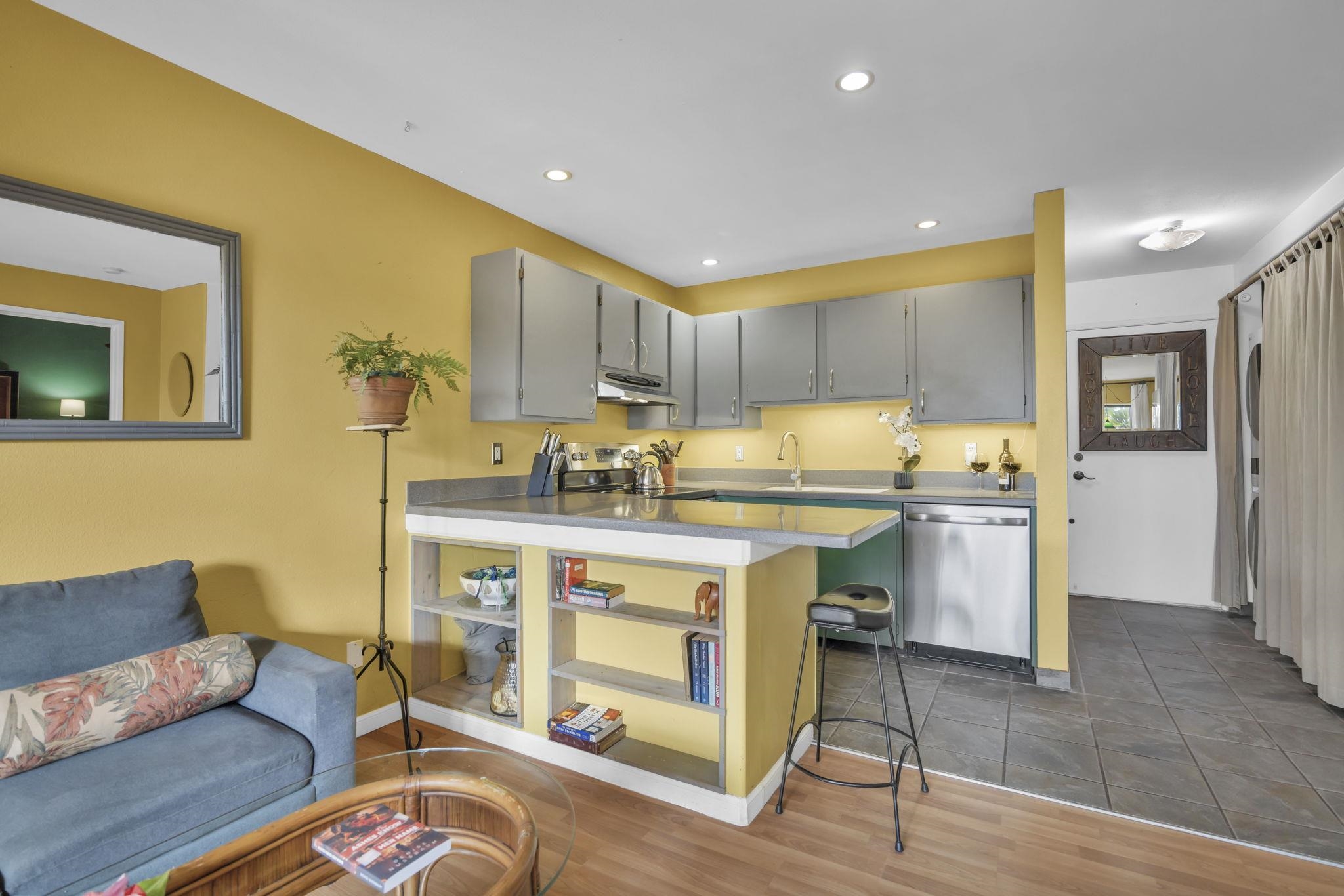 3740 Lower Honoapiilani Road, Unit C205 Lahaina, HI 96761 - Photo 9 of 28 a kitchen with a sink dishwasher a stove and a refrigerator with wooden floor