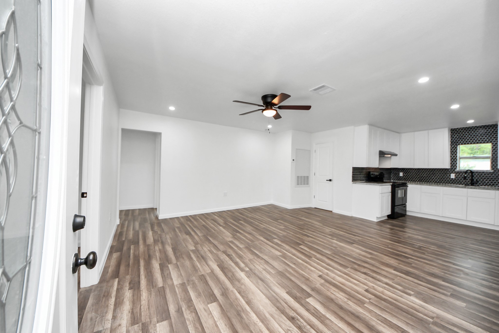 207 East Defee Avenue Baytown, TX 77520 - Photo 8 of 36 a view of empty room with wooden floor