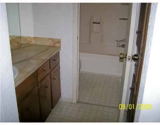 a bathroom with a shower and a sink