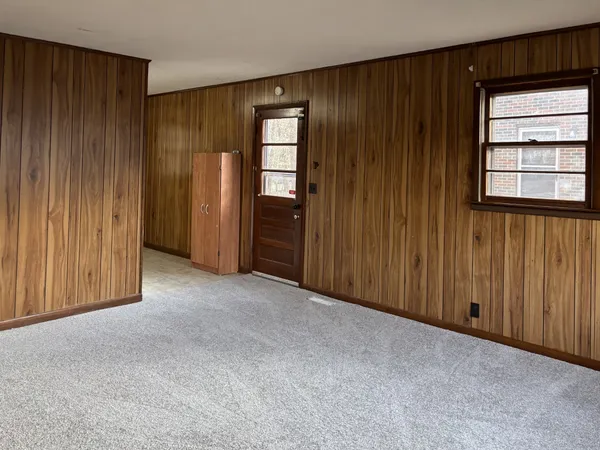 an empty room with windows and closet