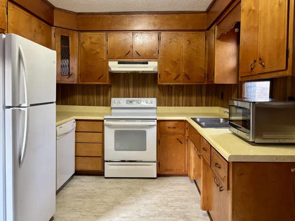 a kitchen with a refrigerator and a stove