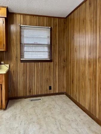 a view of an empty room with wooden walls
