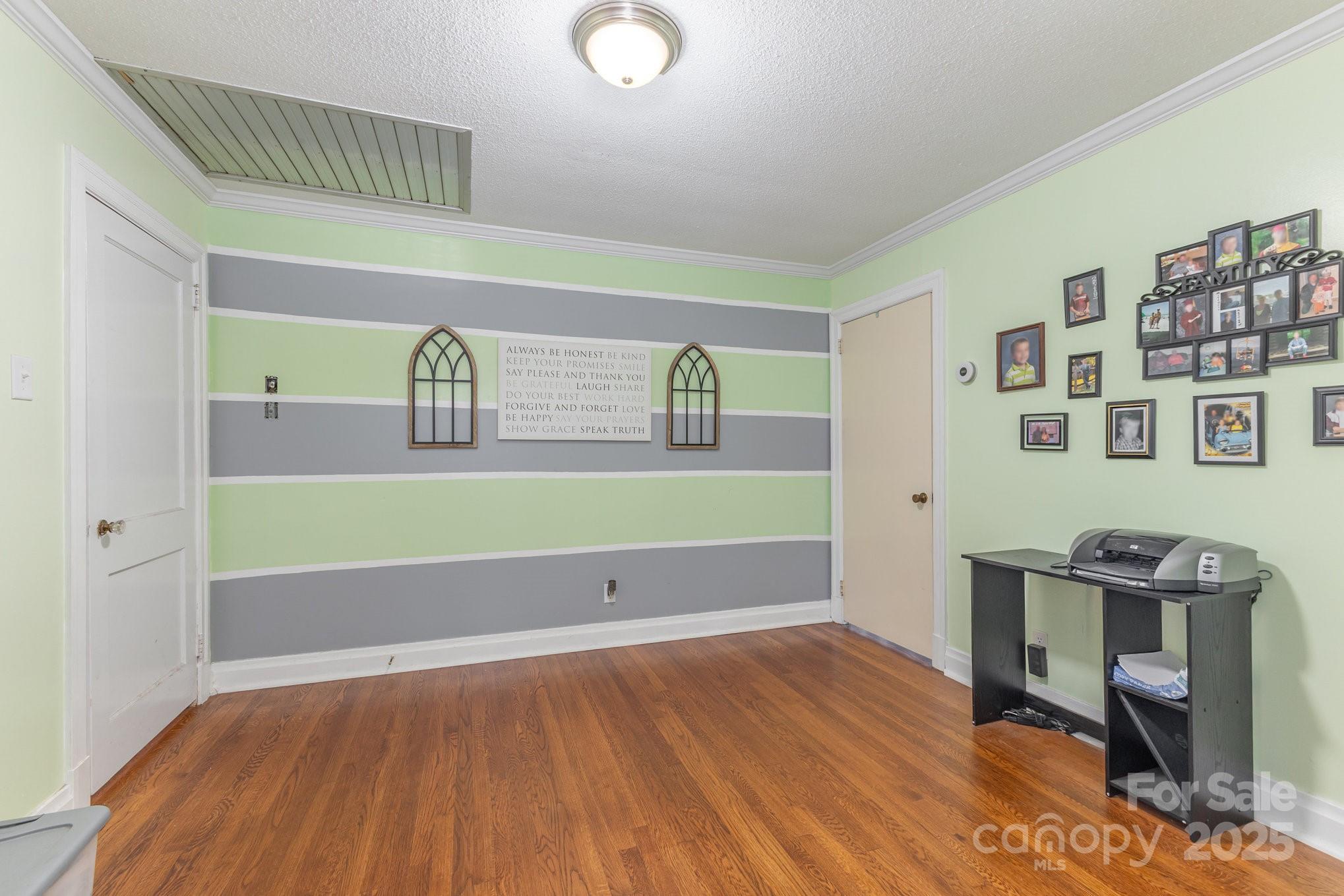 165 Bailey Road Lancaster, SC 29720 - Photo 14 of 33 a room with a workspace and a wooden floor