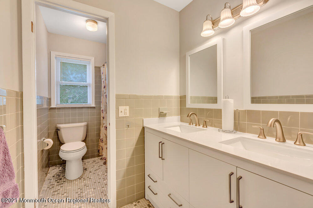 139 Queen Ann Road Brick, NJ 08723 - Photo 16 of 35 a bathroom with a sink a toilet and a mirror