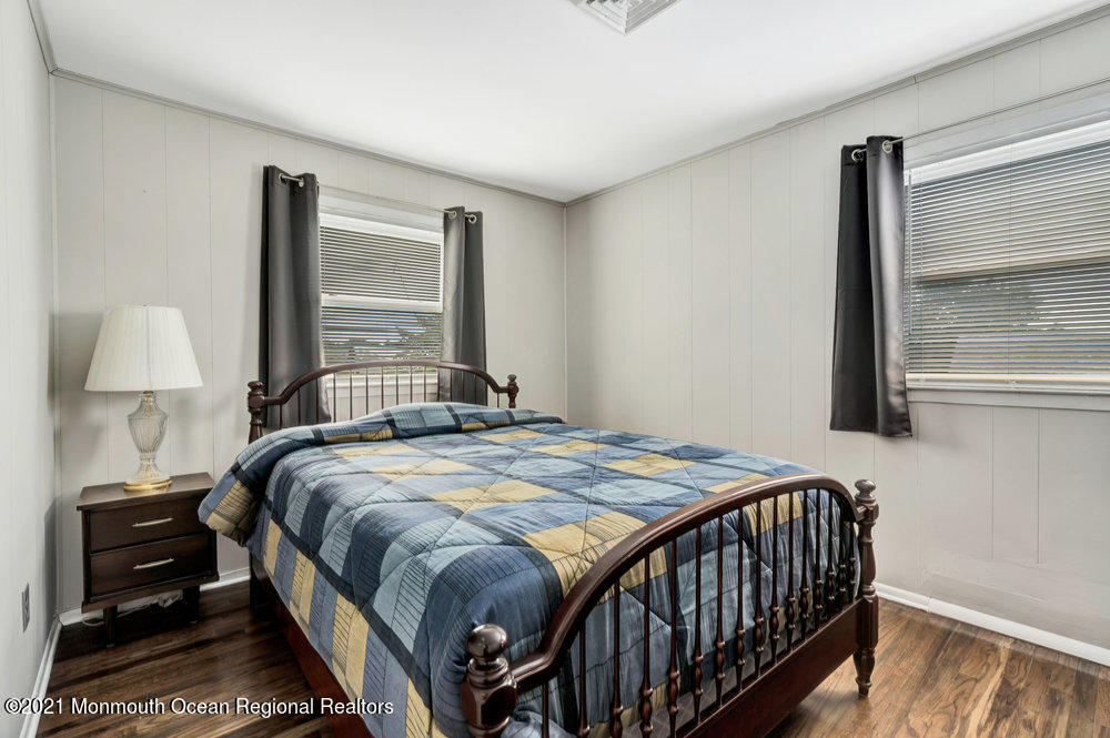 139 Queen Ann Road Brick, NJ 08723 - Photo 18 of 35 a bedroom with a bed and wooden floor