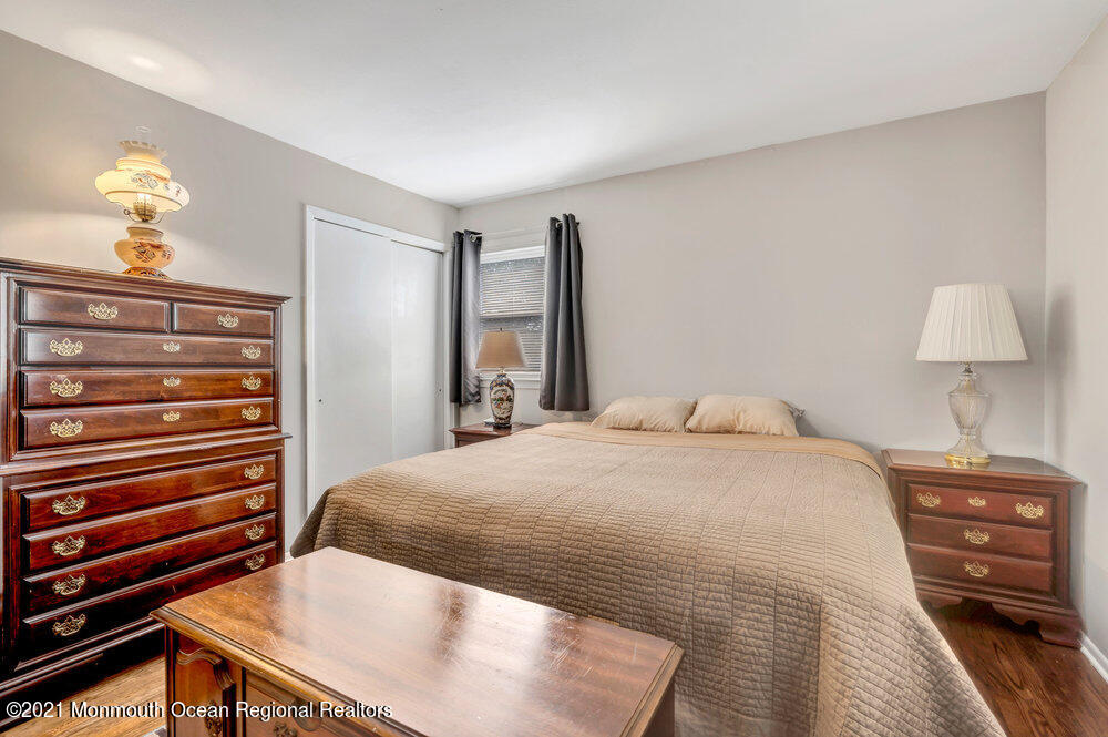 139 Queen Ann Road Brick, NJ 08723 - Photo 20 of 35 a bedroom with a bed and a chandelier