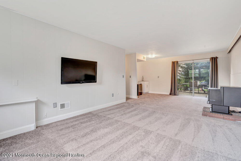 139 Queen Ann Road Brick, NJ 08723 - Photo 24 of 35 a living room with furniture and a flat screen tv