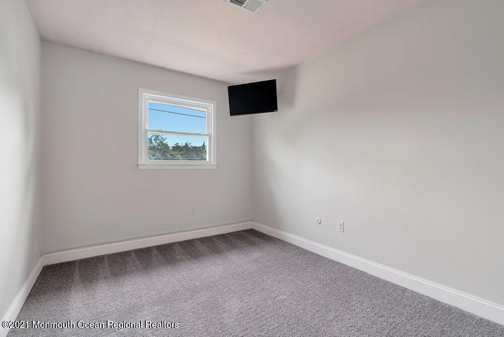 139 Queen Ann Road Brick, NJ 08723 - Photo 27 of 35 an empty room with a workbench