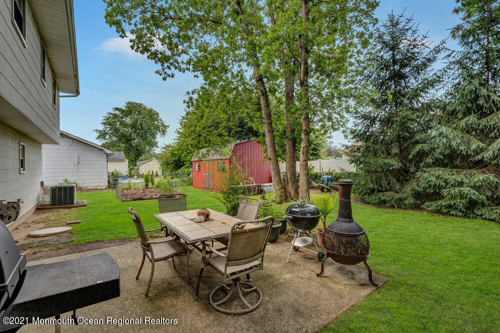 139 Queen Ann Road Brick, NJ 08723 - Photo 29 of 35 a view of backyard with patio and outdoor seating