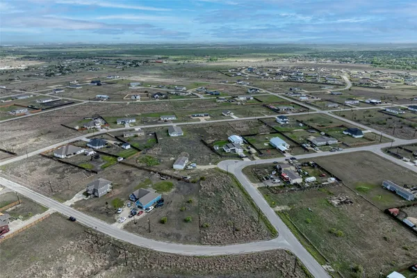 an aerial view of a residential houses with outdoor space