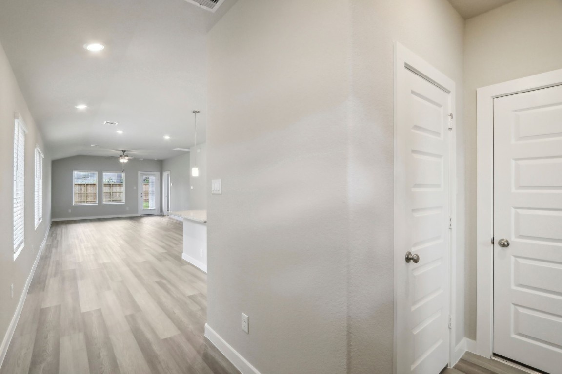 14174 Granger Pointe Lane Conroe, TX 77302 - Photo 3 of 9 a view of a hallway with wooden floor